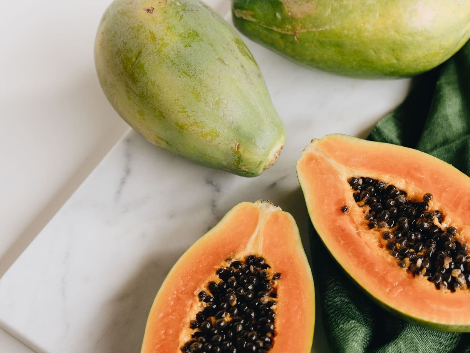 Red Papaya, cut out against a plain background.